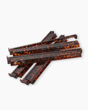 Set of tortoiseshell-patterned mahjong racks on a white background