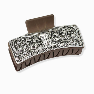 Decorative silver hair clip on a white background