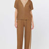 taupe colored crop pants with lighter color stripe on bottom