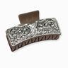 Decorative silver hair clip on a white background
